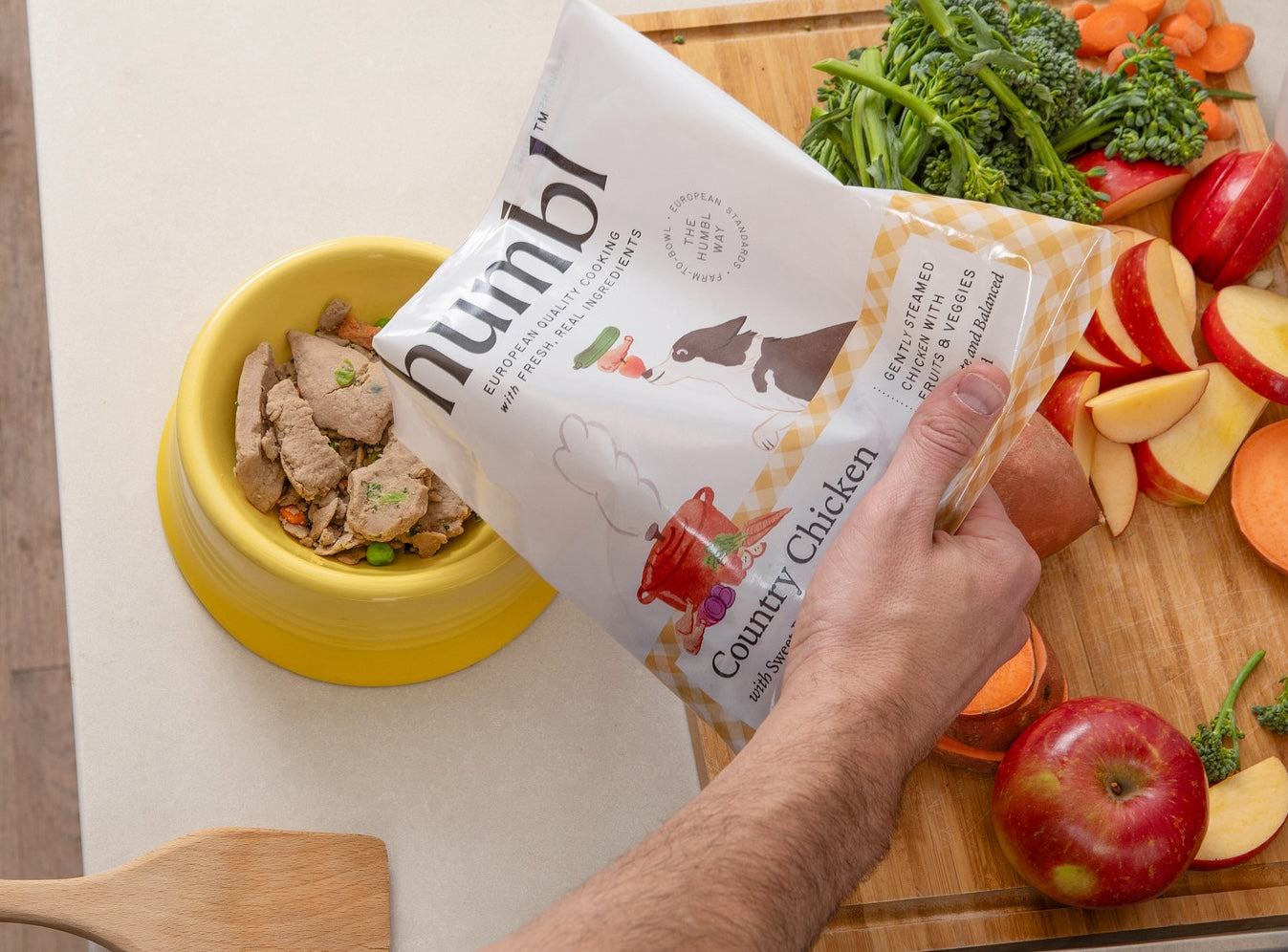 pouring country chicken dog food into bowl